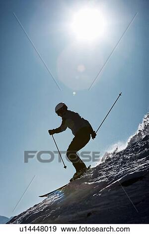 Stock Photo - Skier coasting on snowy slope. Fotosearch
