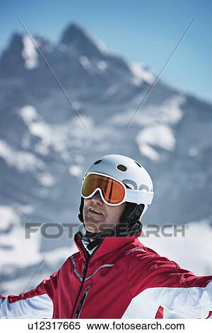 Skier standing on snowy mountain View Large Photo Image Stock Photography - Skier standing on snowy mountain. Fotosearch