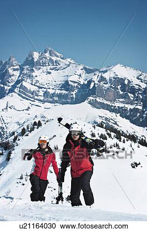 Skiers climbing snowy mountainside View Large Photo Image Stock Image - Skiers climbing snowy mountainside. Fotosearch