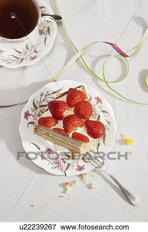 Slice of birthday cake with tea View Large Photo Image Stock Photo - Slice of birthday cake with tea. Fotosearch