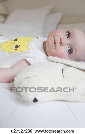 Smiling baby laying on bed View Large Photo Image Stock Photo - Smiling baby laying on bed. Fotosearch