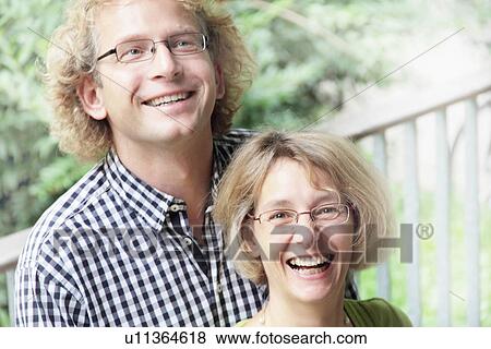 Smiling couple standing outdoors View Large Photo Image Stock Photo - Smiling couple standing outdoors. Fotosearch