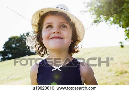 Stock Photograph - Smiling girl walking outdoors. Fotosearch