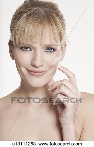 Smiling woman applying makeup View Large Photo Image Stock Photo - Smiling woman applying makeup. Fotosearch