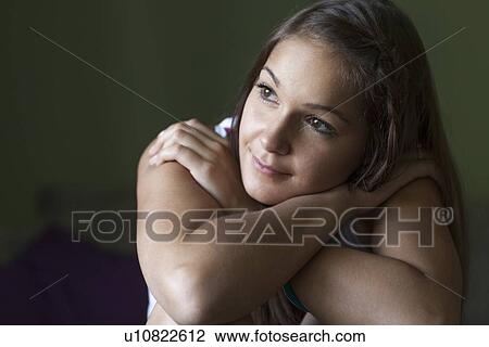 Smiling woman hugging her knees View Large Photo Image Stock Image - Smiling woman hugging her knees. Fotosearch