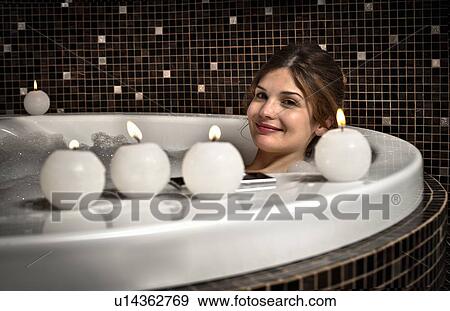 Stock Photo - Smiling woman relaxing in bath. Fotosearch