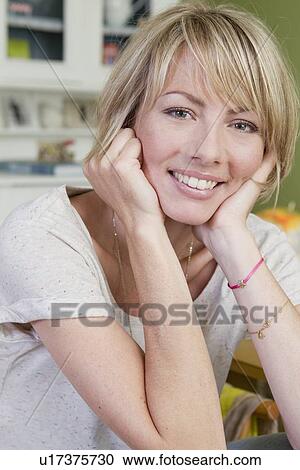 Smiling woman resting chin in hands View Large Photo Image Stock Image - Smiling woman resting chin in hands. Fotosearch