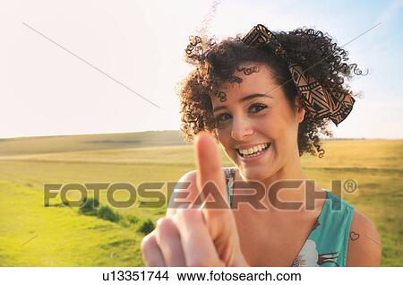 Smiling woman standing in meadow View Large Photo Image Picture - Smiling woman standing in meadow. Fotosearch