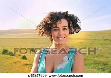 Stock Photo - Smiling woman standing in meadow. Fotosearch