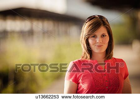 Smiling woman standing outdoors View Large Photo Image Stock Image - Smiling woman standing outdoors. Fotosearch