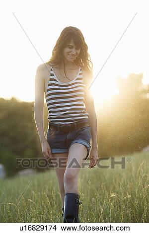 Picture - Smiling woman walking outdoors. Fotosearch