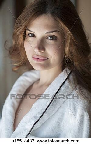 Stock Photo - Smiling woman wearing bathrobe. Fotosearch