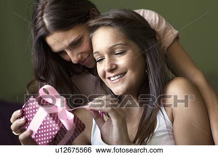 Smiling women exchanging gifts View Large Photo Image Stock Photograph - Smiling women exchanging gifts. Fotosearch