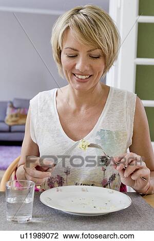 Smiling women having lunch together View Large Photo Image Stock Image - Smiling women having lunch together. Fotosearch