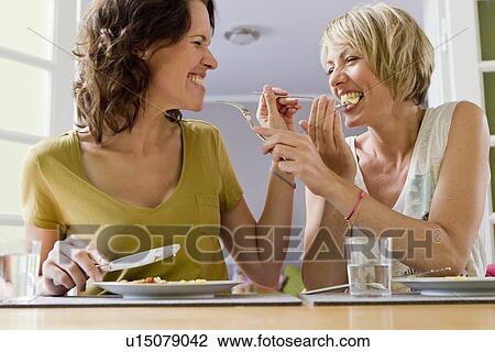 Smiling women having lunch together View Large Photo Image Stock Image - Smiling women having lunch together. Fotosearch