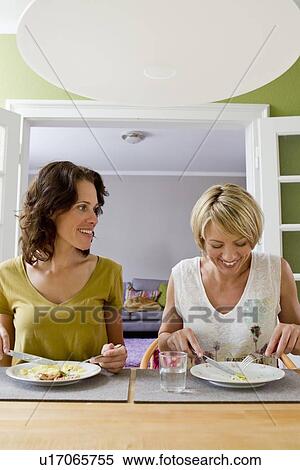 Smiling women having lunch together View Large Photo Image Stock Photography - Smiling women having lunch together. Fotosearch
