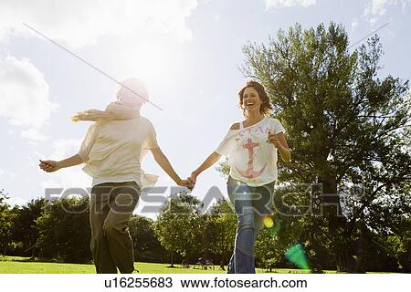 Smiling women running outdoors View Large Photo Image Stock Image - Smiling women running outdoors. Fotosearch