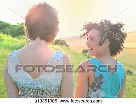 Smiling women standing in meadow View Large Photo Image Stock Photography - Smiling women standing in meadow. Fotosearch