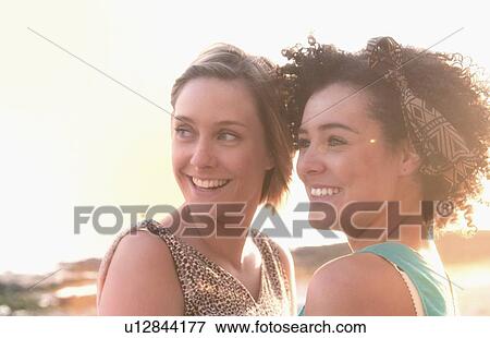 Smiling women standing together View Large Photo Image Stock Photo - Smiling women standing together. Fotosearch