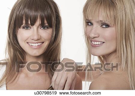 Stock Photo - Smiling women standing together. Fotosearch