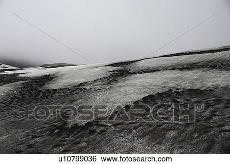 Stock Photograph - Snow in frozen rocky landscape. Fotosearch