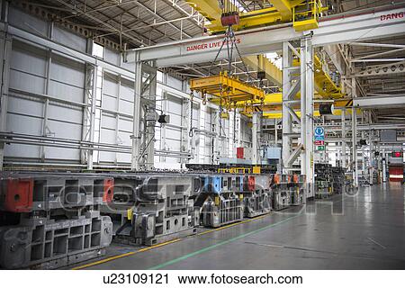 Stock Image - Steel moulds for pressing car body parts in car factory. Fotosearch