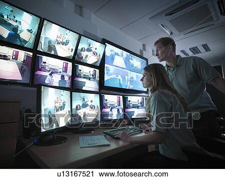 Stock Image - Students working in forensic screen room. Fotosearch