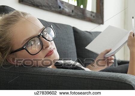 Teenage girl reading on sofa View Large Photo Image Stock Image - Teenage girl reading on sofa. Fotosearch