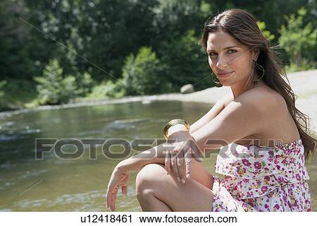 Teenage girl sitting in rural stream View Large Photo Image Stock Image - Teenage girl sitting in rural stream. Fotosearch