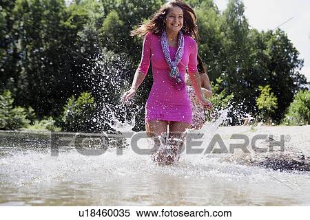 Teenage girl splashing in rural stream View Large Photo Image Stock Photography - Teenage girl splashing in rural stream. Fotosearch