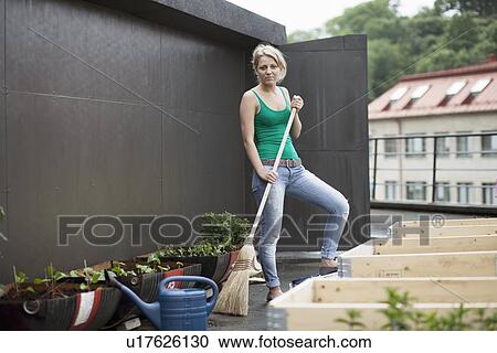 Stock Image - Teenage girl working in modern garden. Fotosearch