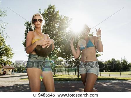Stock Photography - Teenage girls playing basketball. Fotosearch