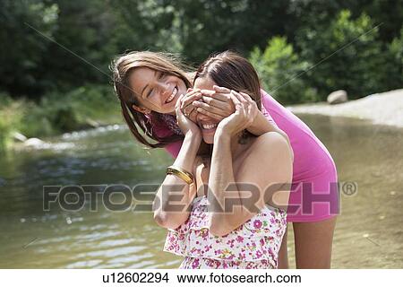 Teenage girls playing in rural stream View Large Photo Image Picture - Teenage girls playing in rural stream. Fotosearch