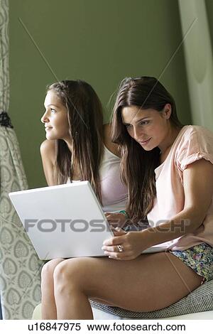 Teenage girls using laptop together View Large Photo Image Stock Photography - Teenage girls using laptop together. Fotosearch