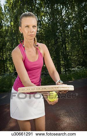 Stock Image - Tennis player serving on court. Fotosearch