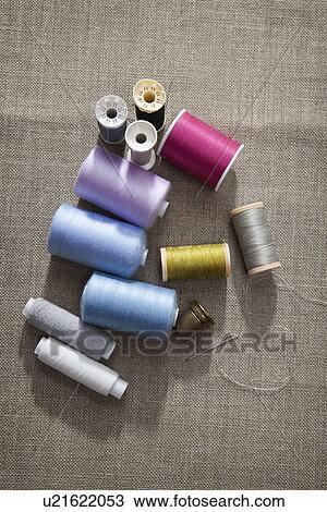 Stock Image - Thread, sewing needle and thimble. Fotosearch