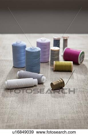 Stock Photo - Thread, sewing needle and thimble. Fotosearch
