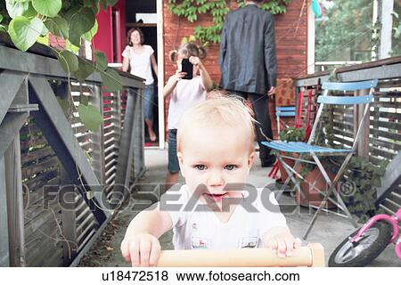 Stock Photo - Toddler playing in backyard. Fotosearch