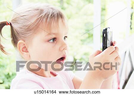 Toddler playing with cell phone View Large Photo Image Picture - Toddler playing with cell phone. Fotosearch