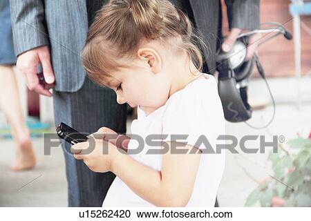 Toddler playing with cell phone View Large Photo Image Stock Image - Toddler playing with cell phone. Fotosearch