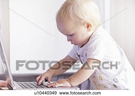 Toddler playing with laptop View Large Photo Image Stock Photo - Toddler playing with laptop. Fotosearch
