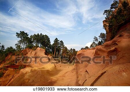 Stock Image - Trees growing on desert hills. Fotosearch