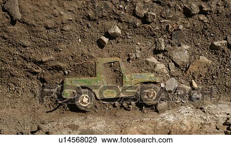 Stock Photo - Truck compounded in dirt and stones. Fotosearch