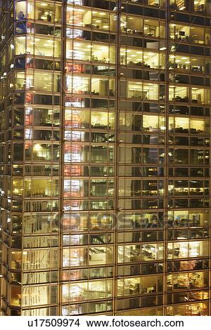 Picture - Urban office building lit up at night. Fotosearch