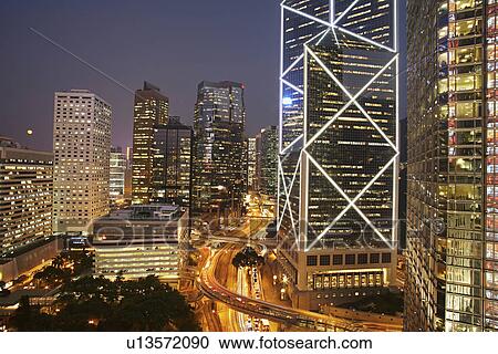 Urban skyscrapers lit up at night View Large Photo Image Stock Image - Urban skyscrapers lit up at night. Fotosearch