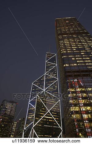 Urban skyscrapers lit up at night View Large Photo Image Stock Photo - Urban skyscrapers lit up at night. Fotosearch