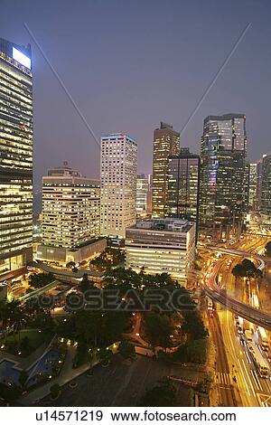 Urban skyscrapers lit up at night View Large Photo Image Stock Photo - Urban skyscrapers lit up at night. Fotosearch