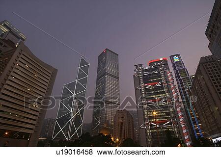 Urban skyscrapers lit up at night View Large Photo Image Stock Photo - Urban skyscrapers lit up at night. Fotosearch