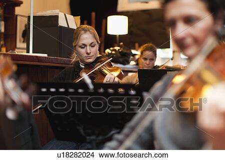 Violin player practicing with group View Large Photo Image Picture - Violin player practicing with group. Fotosearch