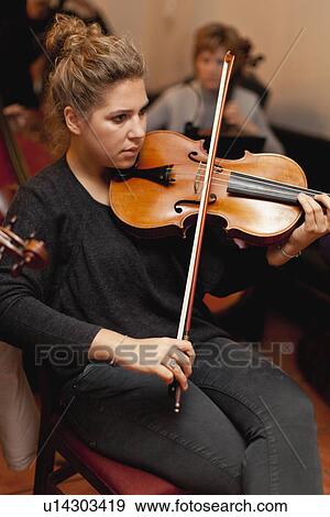 Violin player practicing with group View Large Photo Image Stock Photo - Violin player practicing with group. Fotosearch